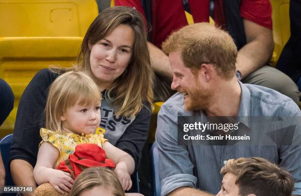 Prince Harry sits with David Henson's wife Hayley Henson and daugther Emily Henson at the Sitting Volleyball Finals on day 5 of the Invictus Games...