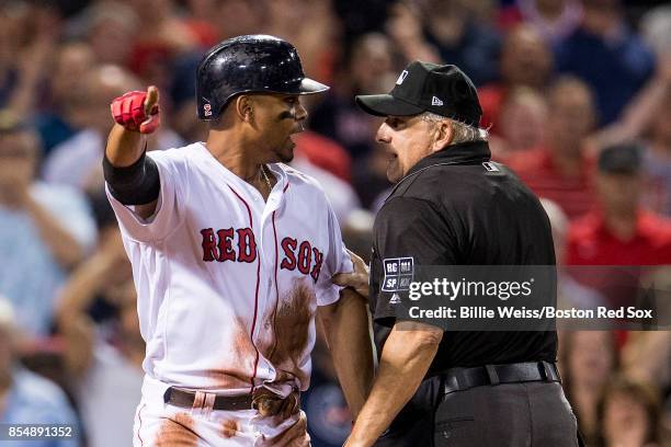 Xander Bogaerts of the Boston Red Sox argues with home plate umpire Larry Vanover after being called out on a tag by Russell Martin of the Toronto...