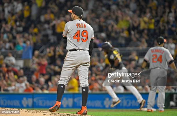 Gabriel Ynoa of the Baltimore Orioles reacts as Josh Bell of the Pittsburgh Pirates rounds the bases after hitting a two run home run in the third...