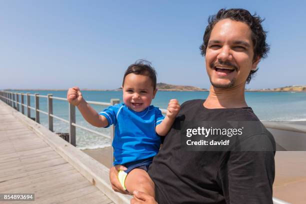 aboriginal australian father and son at the beach - aboriginal man imagens e fotografias de stock