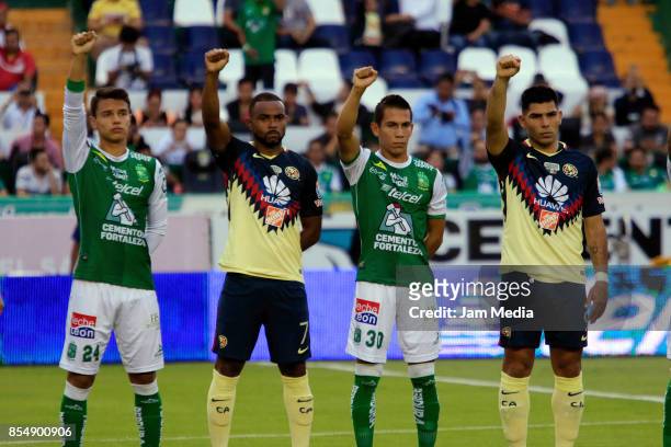Osvaldo Rodriguez of Leon , William of America and Jose Rodriguez of Leon and Silvio Romero of America raise their fists during a minute of silence...