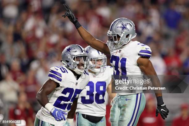 Free safety Byron Jones of the Dallas Cowboys reacts with safety Xavier Woods of the Dallas Cowboys after breaking up a fourth down pass during the...