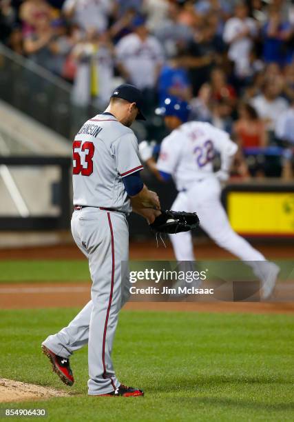 Jim Johnson of the Atlanta Braves looks on after surrendering a seventh inning three run home run against Dominic Smith of the New York Mets at Citi...