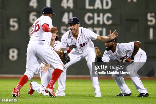 Rajai Davis of the Boston Red Sox, Andrew Benintendi, Joe Kelly, and Jackie Bradley Jr. #19 celebrate after defeating the Toronto Blue Jays 10-7 at...