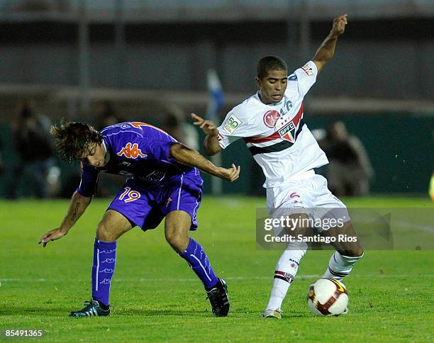 Julio Marchant of Uruguay's Defensor Sporting fights for the ball with Junior Cesar of Brazil's Sao Paulo during their Libertadores Cup soccer match...