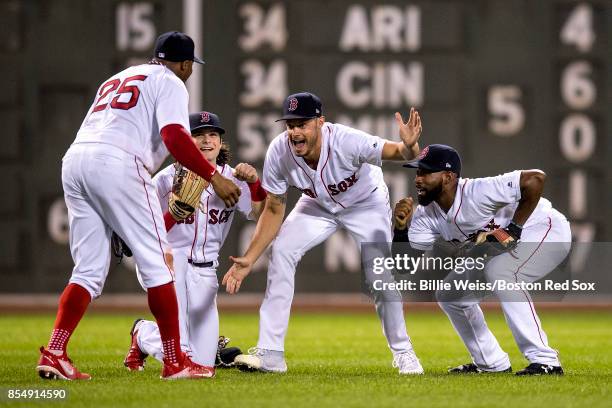 Rajai Davis of the Boston Red Sox, Andrew Benintendi, Joe Kelly, and Jackie Bradley Jr. #19 celebrate a victory against the Toronto Blue Jays on...