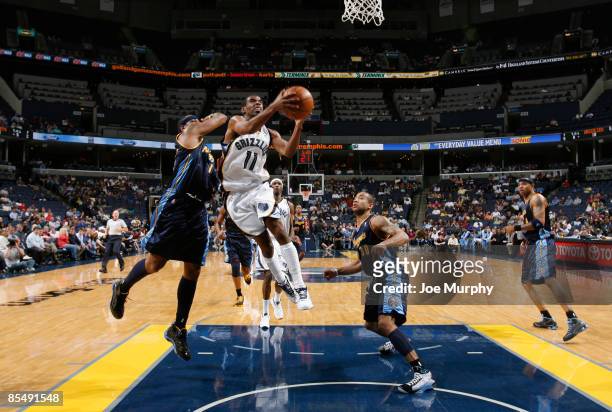 Mike Conely of the Memphis Grizzlies shoots a layup against the Denver Nuggets on March 18, 2009 at FedExForum in Memphis, Tennessee. NOTE TO USER:...