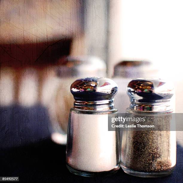 salt and pepper shakers on blue table - pepper pot stock pictures, royalty-free photos & images