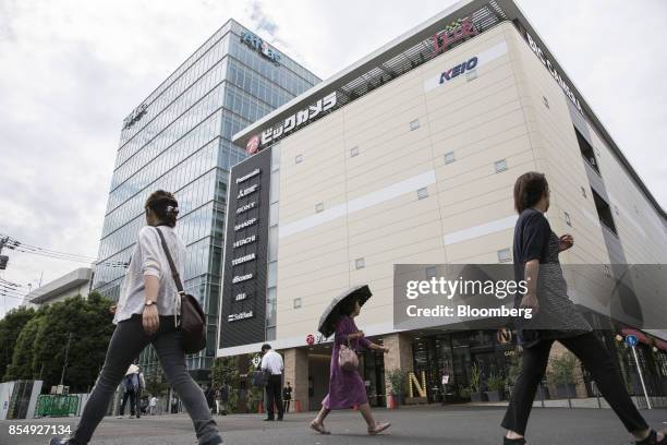 People walk past a Bic Camera Keio Chofu store, operated by Bic Camera Inc., at the Trie Keio Chofu Shopping Center in Chofu, Tokyo, on Wednesday,...