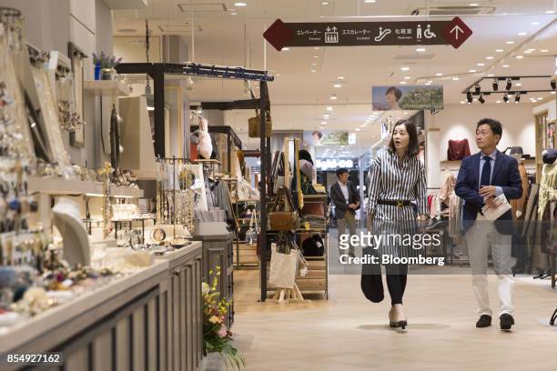 People walk past stores during a media tour of the Trie Keio Chofu Shopping Center, operated by Keio Corp., in Chofu, Tokyo Metropolis, Japan, on...