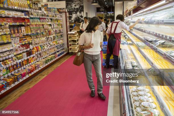 Customer walks past noodles displayed for sale at a Seijo Ishii Inc. Grocery store during a media tour of the Trie Keio Chofu Shopping Center,...