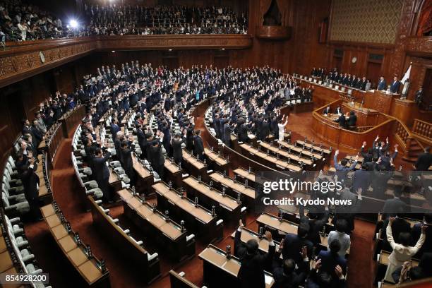 Several lawmakers throw their arms in the air in a customary "banzai" when the House of Representatives was dissolved on Sept. 28 for a general...