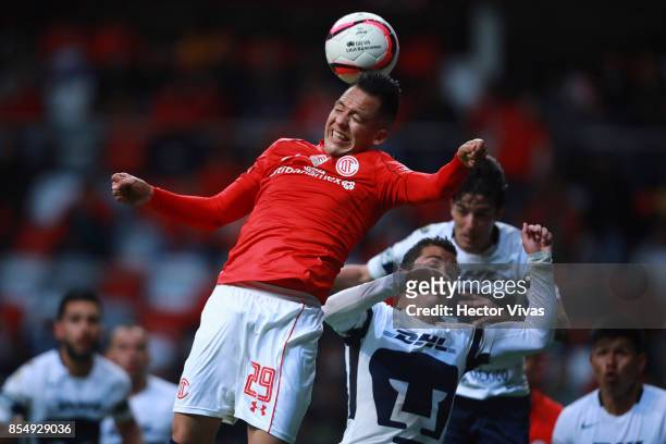 Rodrigo Salinas of Toluca struggles for the ball with Alan Mozo of Pumas during the 11th round match between Toluca and Pumas UNAM as part of the...