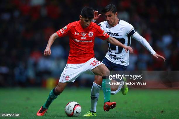 Pablo Barrientos of Toluca struggles for the ball with Josecarlos Van Rankin of Pumas during the 11th round match between Toluca and Pumas UNAM as...