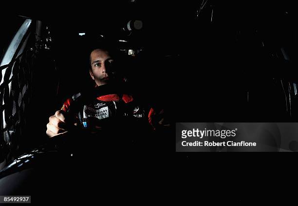 Michael Caruso driver of the Garry Rogers Motorsport Holden poses for a portrait in the pit garages in preperation for the Clipsal 500, round one of...