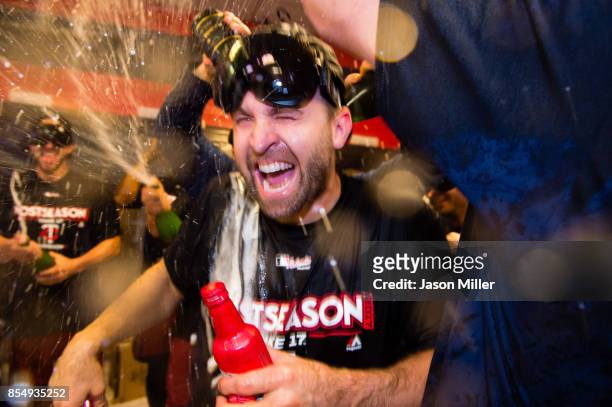 Brian Dozier of the Minnesota Twins celebrates with his teammates after the Minnesota Twins clinched the second Wild Card spot of the American League...