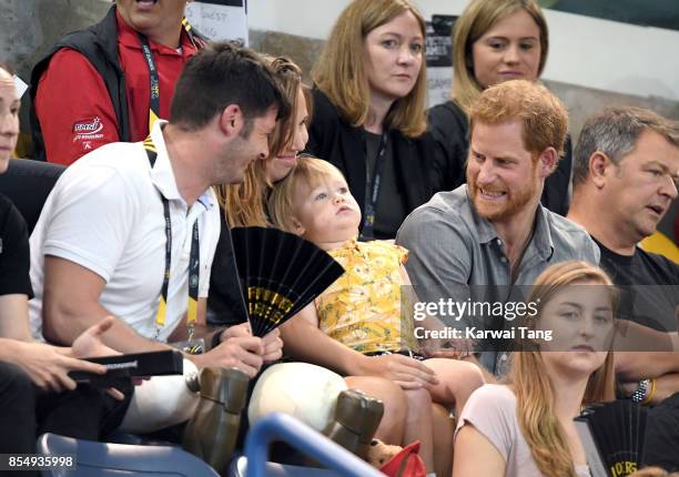 Prince Harry with British Paralympian Dave Henson, his wife Hayley Henson and their two-year-old daughter Emily attend the Seated Volleyball on day 5...