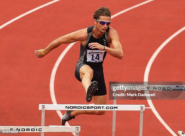 Brendan Cole of the ACT clears a hurdle in the first heat of the Mens 400 Metres Hurdles preliminaris on day one of the Australian Athletics...