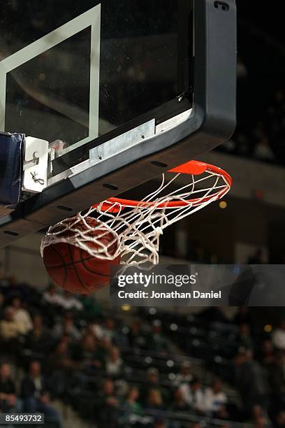 Detail of a spalding basketball going through the net as the Minnesota Golden Gophers play against the Northwestern Wildcats during the first round...