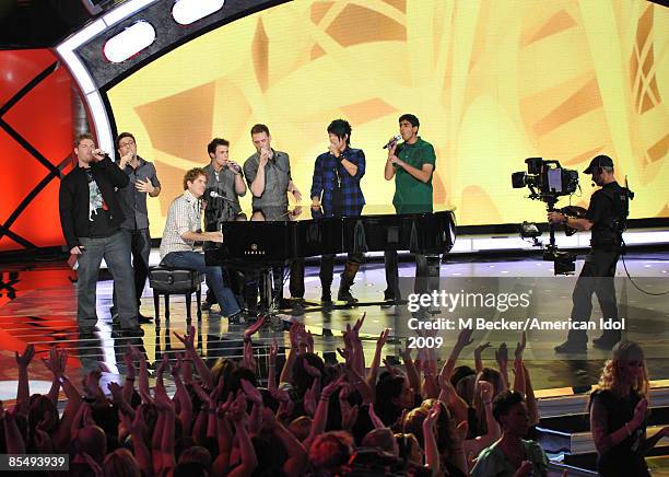 Contestants Michael Sarver, Danny Gokey, Scott MacIntyre, Kris Allen, Matt Giraud, Adam Lambert and Anoop Desai perform onstage during the live...