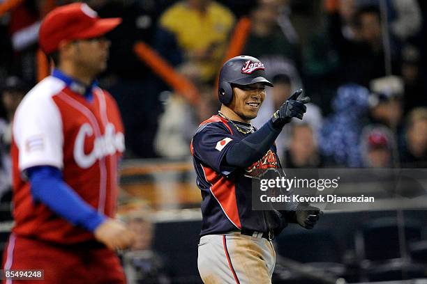 Akinori Iwamura of Japan points to Ichiro Suzuki, after scoring against Cuba during the 2009 World Baseball Classic Round 2 Pool 1 Game 5 on March...