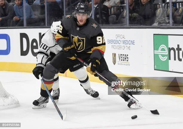 Tomas Nosek of the Vegas Golden Knights looks to pass the puck under pressure from Andrei Loktionov of the Los Angeles Kings during a preseason game...