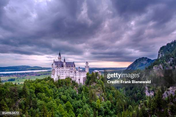 Neuschwanstein Castle at sunrise, seen from the bridge Marienbrücke, built high above the Pöllat Gorge.