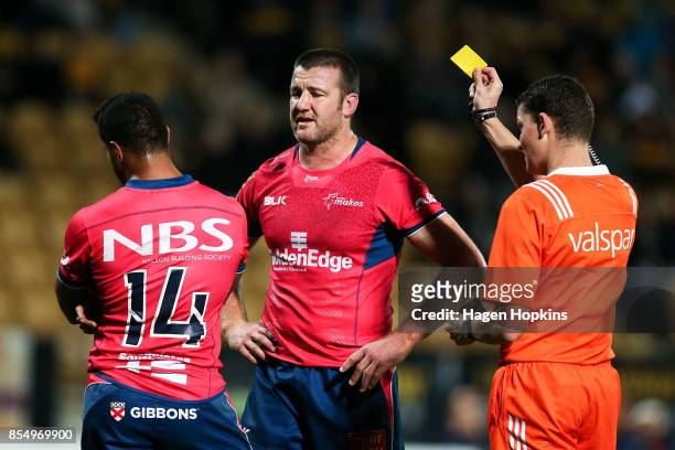 Referee Angus Maybe shows Viliami Lolohea of Tasman a second yellow card before giving a red card while Alex Ainley looks on during the round seven...
