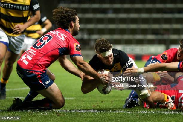 Lachlan Boshier of Taranaki scores a try under pressure from Billy Guyton of Tasman during the round seven Mitre 10 Cup match between Taranaki and...