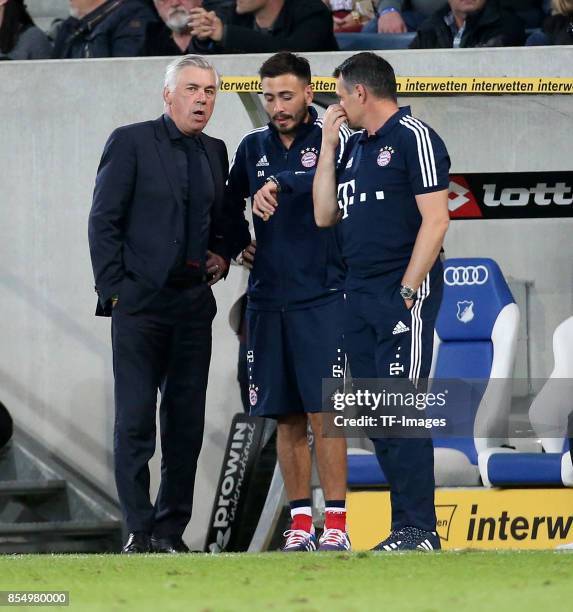 Head coach Carlo Ancelotti of Muenchen and Co-coach Willy Sagnol of Muenchen and Davide Ancelotti of Muenchen looks on during the Bundesliga match...
