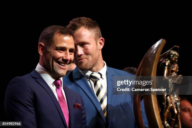 North Queensland Cowboys captain Gavin Cooper talks to Melbourne Storm captain Cameron Smith during the NRL Fan Day at Luna Park on September 28,...