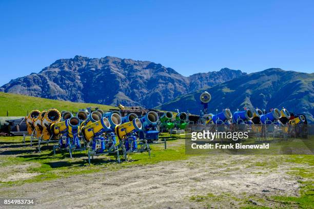Snow cannons, snow blowers are stored on a mountain slope during summer.