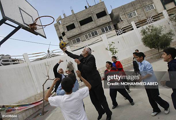 Rabbi, part of a group of imams, priests and rabbis that is visiting the Gaza Strip, plays basketball with Palestinian children at Christian Holy...