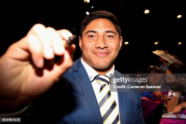 Jason Taumalolo of the Cowboys signs autographs during a NRL Fan Day at Luna Park on September 28, 2017 in Sydney, Australia.