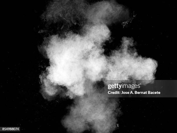 forms and textures of an explosion of a powder of color white on a black background - smoked food stock pictures, royalty-free photos & images