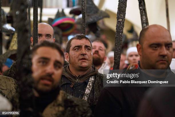 Villagers sing as they hold poles with their hats at the end of El Vitor Civic procession inside the church on September 27, 2017 in Mayorga,...