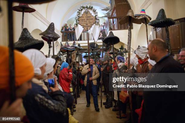 Villagers hold poles with their hats as El Vitor Civic procession arrives to the church on September 27, 2017 in Mayorga, Valladolid province, Spain....