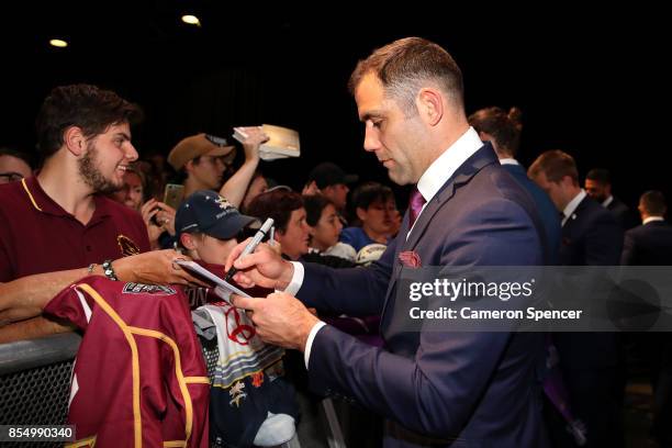 Cameron Smith of the Storm signs autographs during the NRL Fan Day at Luna Park on September 28, 2017 in Sydney, Australia.