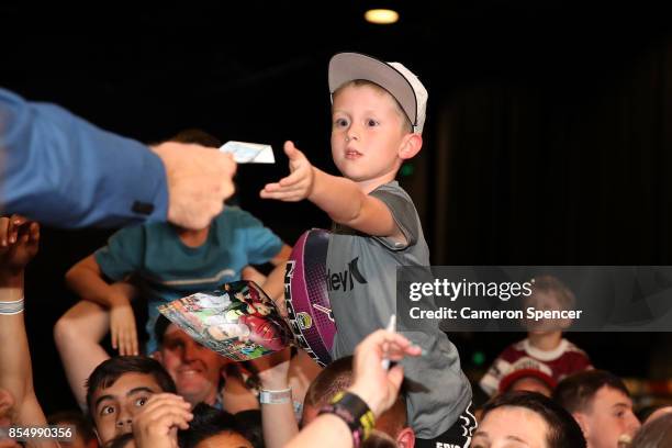 Young fan receives NRL Grand Final tickets during the NRL Fan Day at Luna Park on September 28, 2017 in Sydney, Australia.