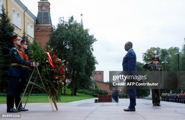 Guinean President Alpha Conde takes part in a wreath-laying ceremony at the Tomb of the Unknown Soldier by the Kremlin wall in Moscow on September...