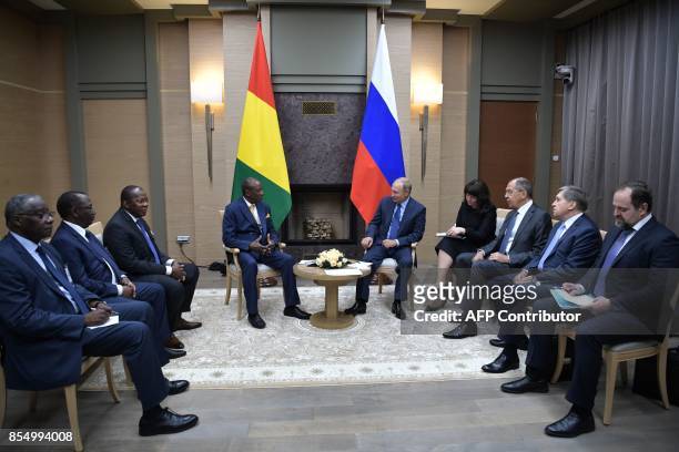 Russian President Vladimir Putin meets with Guinean President Alpha Conde at the Novo-Ogaryovo state residence outside Moscow on September 28, 2017....