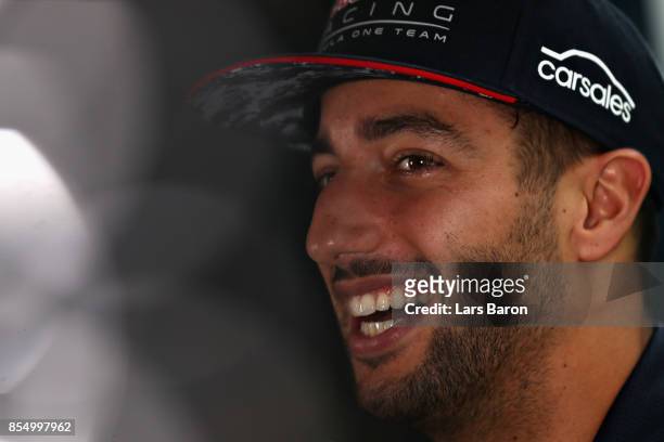 Daniel Ricciardo of Australia and Red Bull Racing talks in the Paddock during previews for the Malaysia Formula One Grand Prix at Sepang Circuit on...