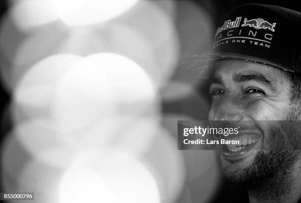 Daniel Ricciardo of Australia and Red Bull Racing talks in the Paddock during previews for the Malaysia Formula One Grand Prix at Sepang Circuit on...