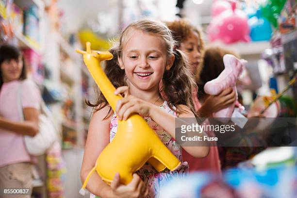 girl in toy store - toy store stock pictures, royalty-free photos & images