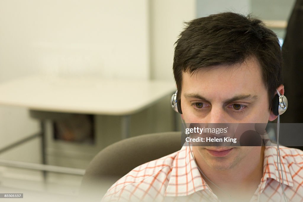 Man Working and Listening to Headphones