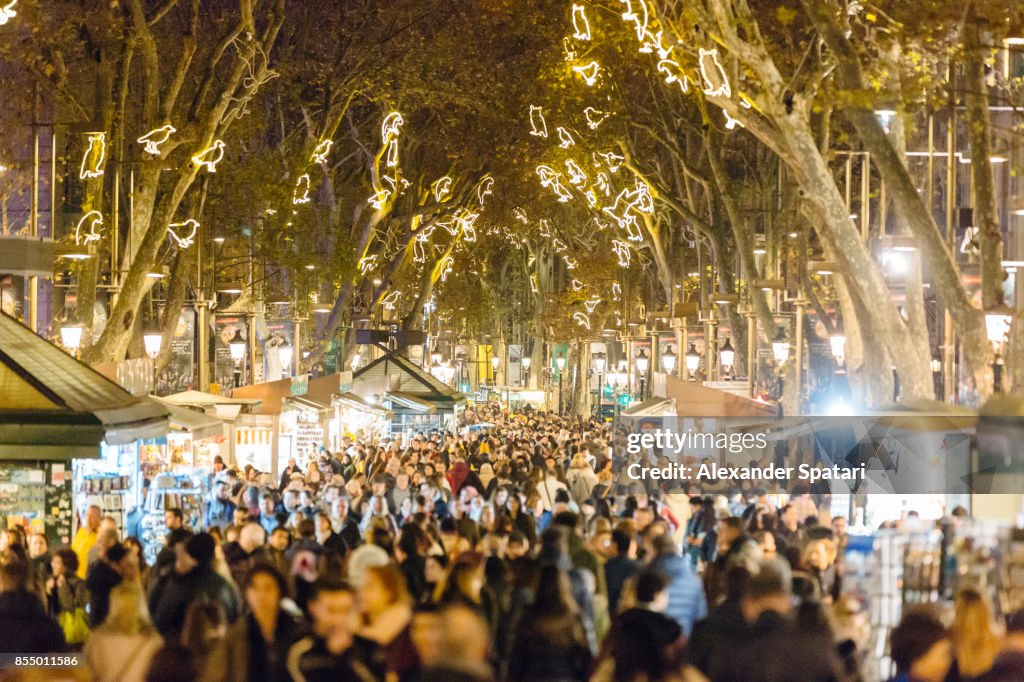 People walking at La Rambla street during Christmas and New Year holidays in Barcelona, Catalonia, Spain