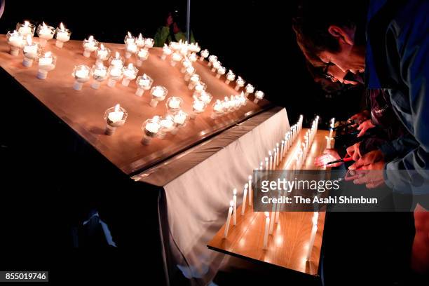 Bereaved family members commemorate victims at Taiyo-no-Oka Park on September 27, 2017 in Kiso, Nagano, Japan. Candles are lit to honour the 63...