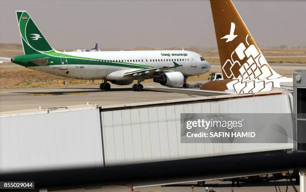 An Iraqi airways plane is pictured on the tarmac at Arbil airport, in the capital of Iraq's autonomous northern Kurdish region, on September 28,...