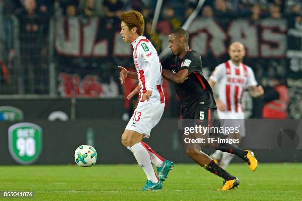 Yuya Osako of Koeln and Gelson Fernandes of Frankfurt battle for the ball during the Bundesliga match between 1. FC Koeln and Eintracht Frankfurt at...