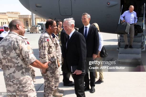 Defense Secretary Jim Mattis and NATO Secretary General Jens Stoltenberg are greeted by US and Qatari military officials upon their arrival at...